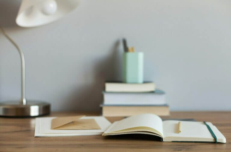 Clear Communication is Key - open notebook on desk with pen